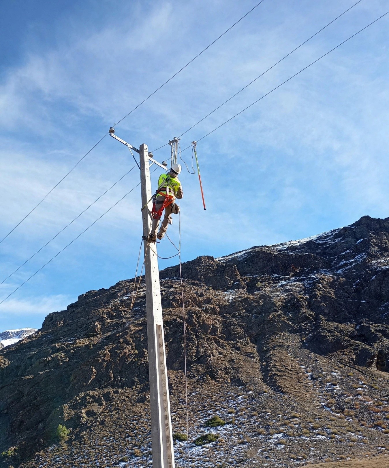 Técnico trabajando en poste eléctrico